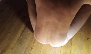 Back view. Jumping on a rubber dildo.