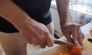 Guy with locked cock is in the kitchen